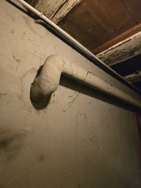 Conduite et son enveloppe isolante dans un local technique.