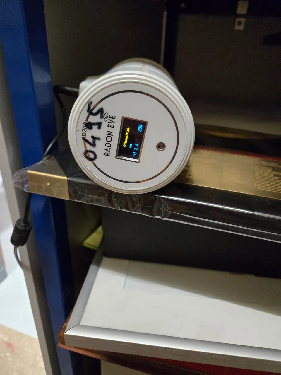 Radon measuring device installed in a building; the display reflects the moment the photo was taken.