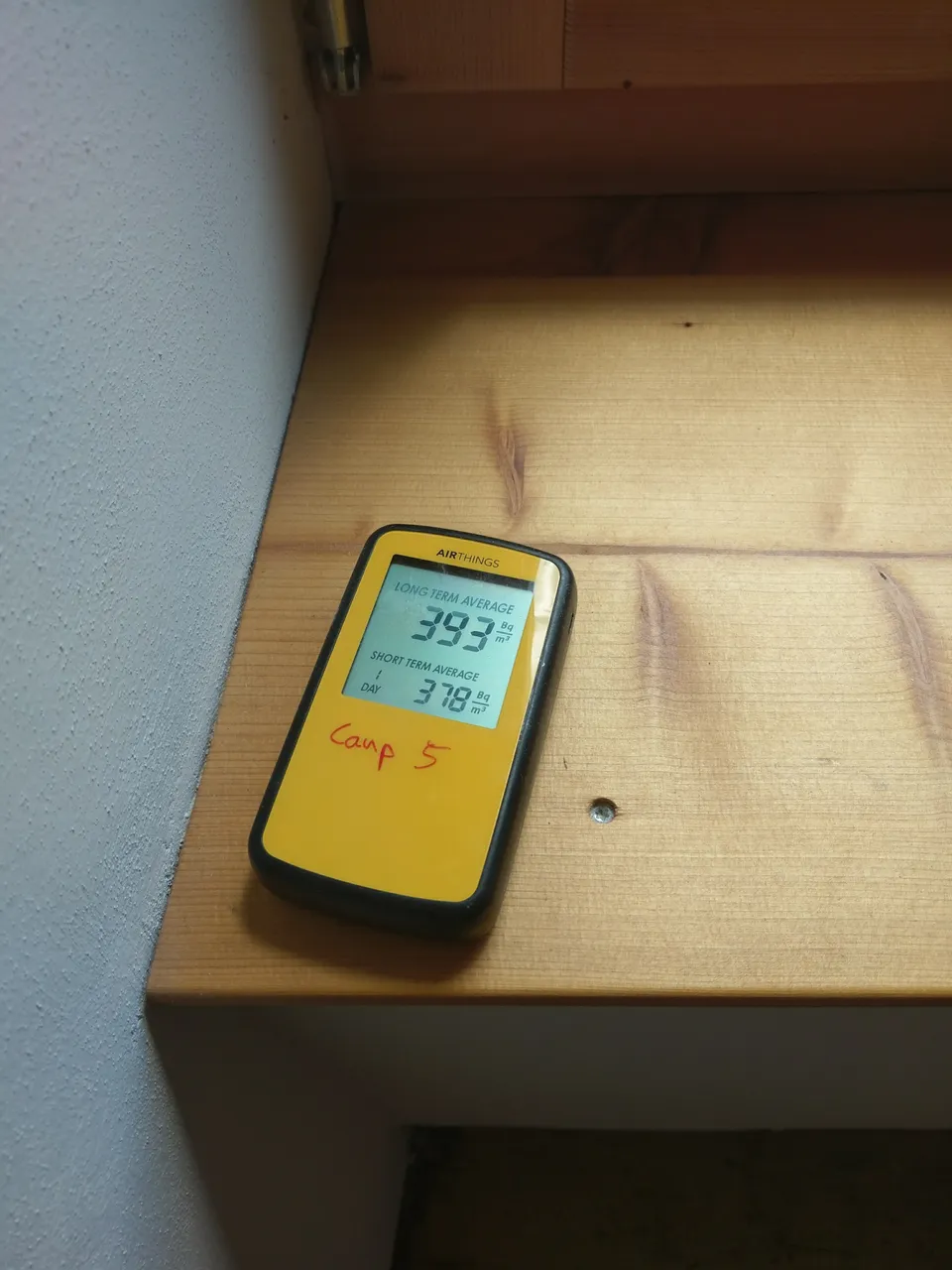 Radon measuring device installed in a building; the display reflects the moment the photo was taken.