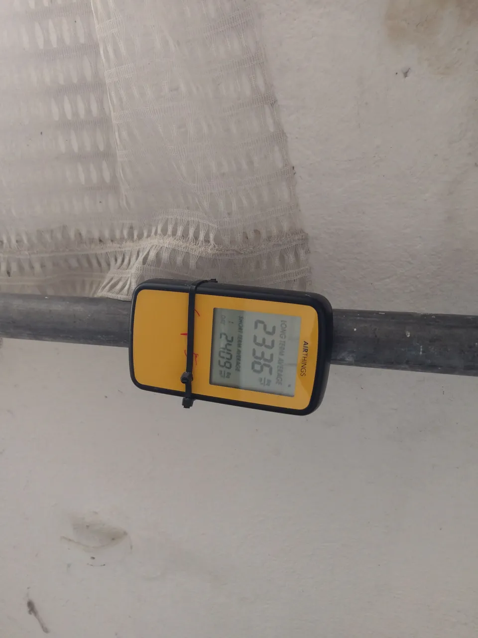 Radon measuring device installed in a building; the display reflects the moment the photo was taken.