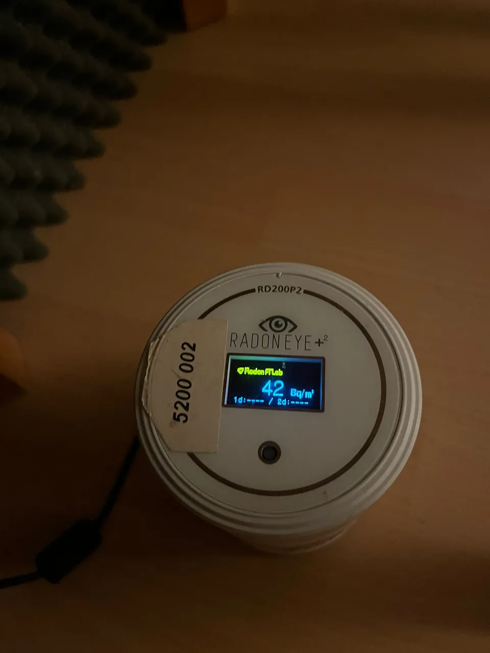 Radon measuring device installed in a building; the display reflects the moment the photo was taken.