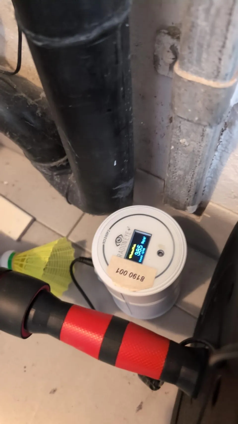 Radon measuring device installed in a building; the display reflects the moment the photo was taken.